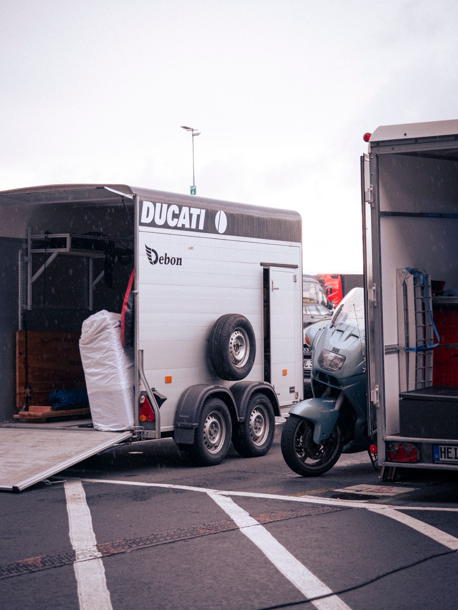 A motorcycle strapped down inside a transport trailer